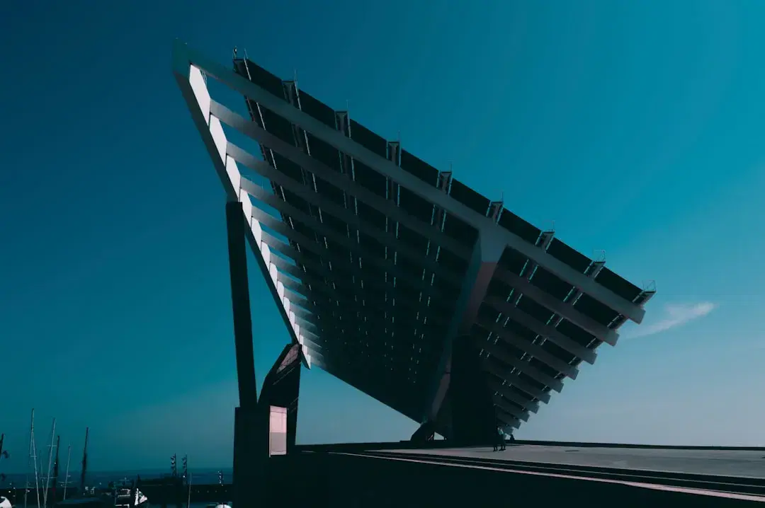 Large elevated solar canopy structure against a deep blue sky