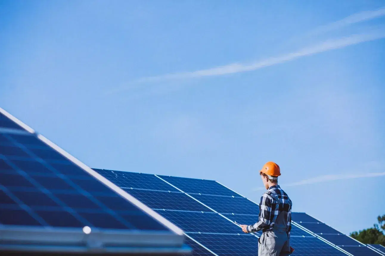 Technician commissioning a rooftop solar array